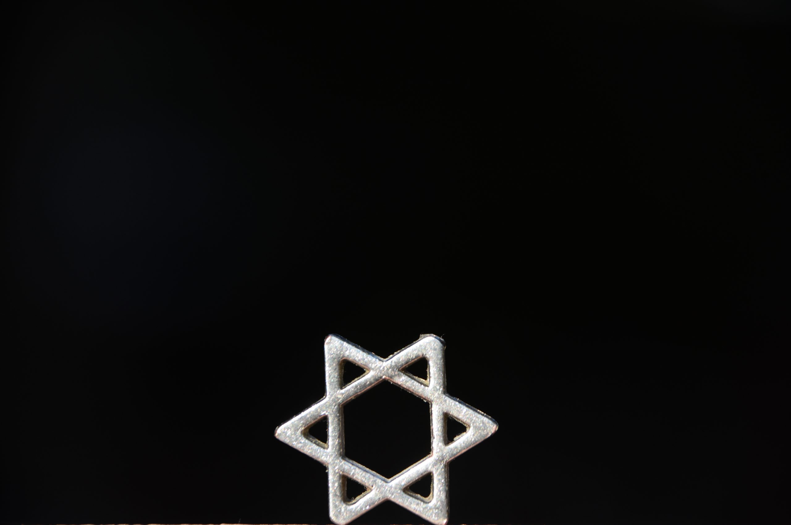 silver jewish star on black background