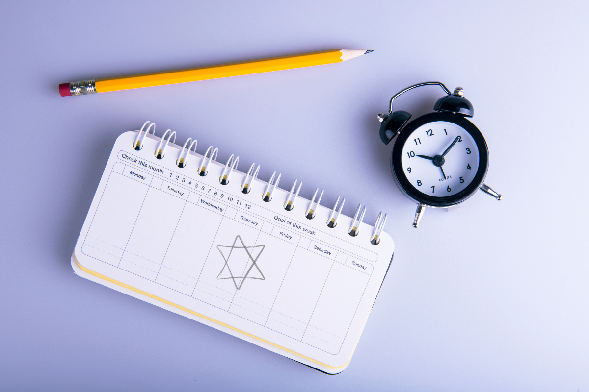 A calendar with a Jewish star, a clock and a pencil