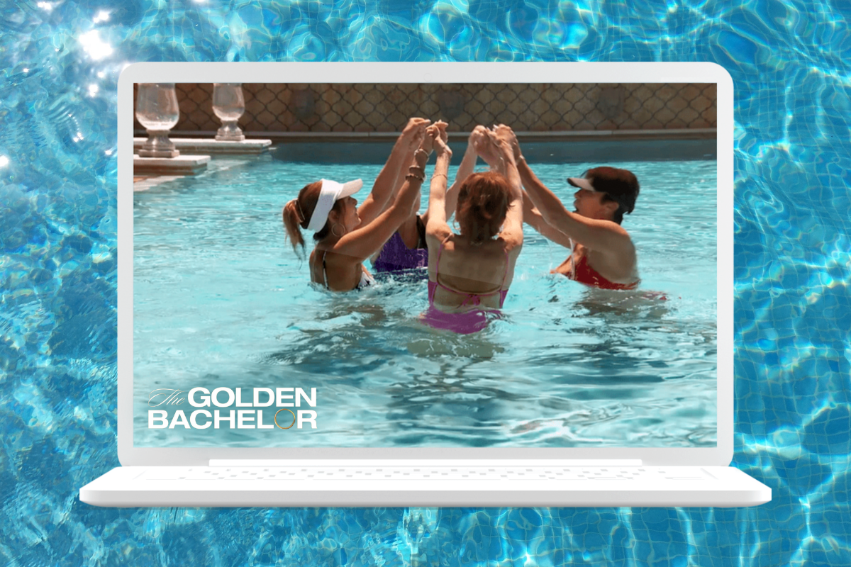 Four women hold hands and dance in a pool