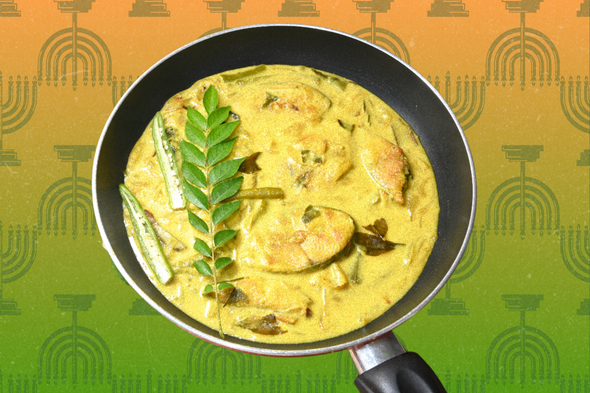 An Indian green fish curry in a pot on a green and orange background with menorahs