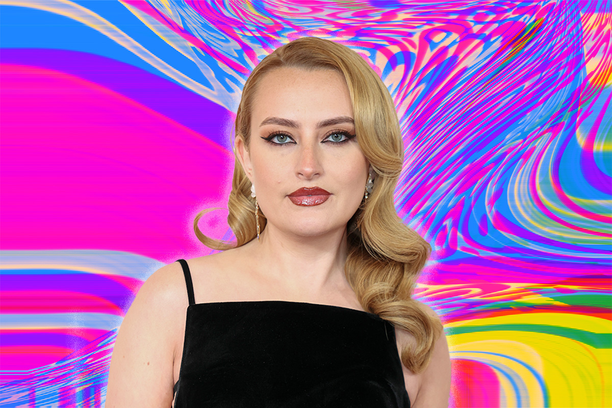 Amelia Dimoldenberg in a black gown on a pink, blue and yellow abstract background
