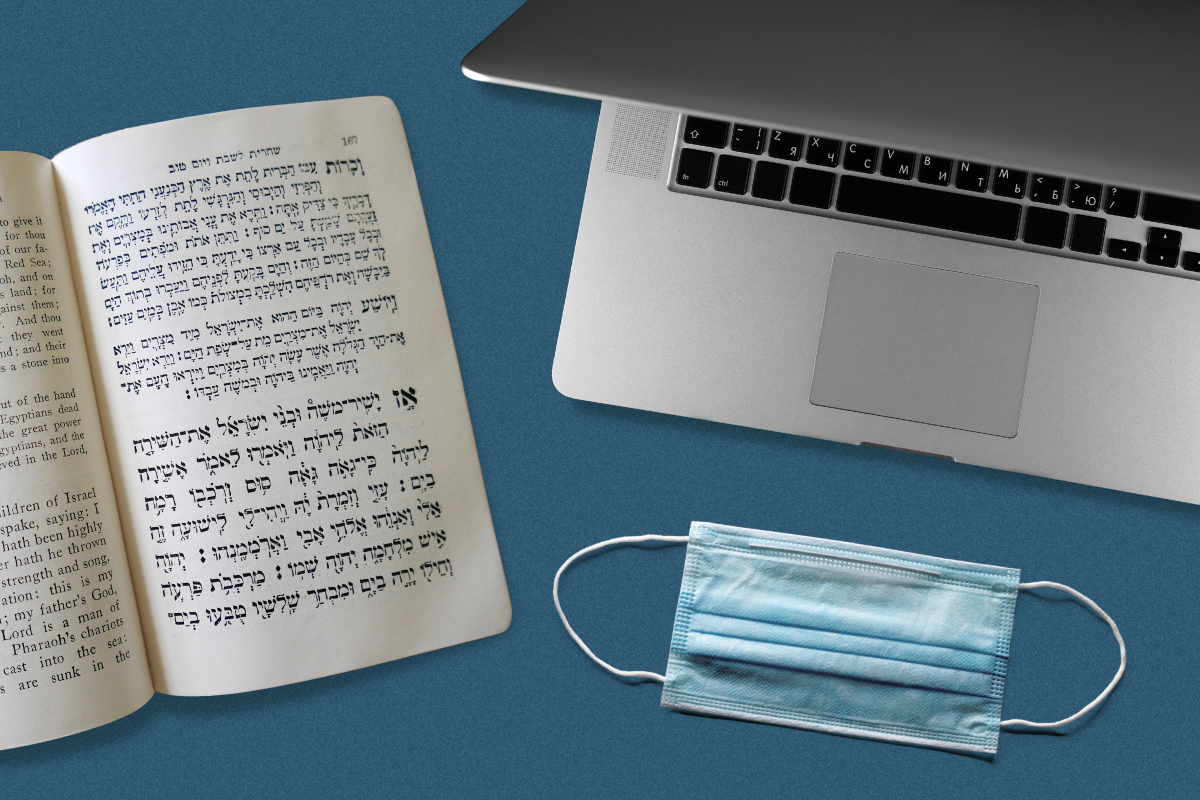 A laptop, blue PPE mask and prayerbook on a blue background