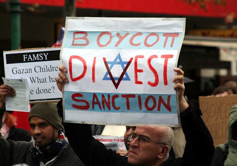 BDS protest in Melbourne, Australia, June 2010. Poster that resembles the Israeli flag reads, "Boycott, divest, sanction."
