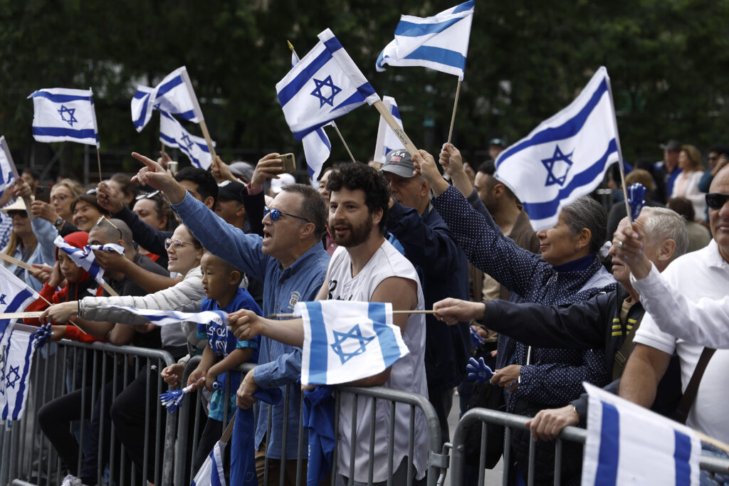 Supporters of a Zionist state attend the Israel Parade in Midtown and wave Israeli flags on June 4, 2023 in New York City.