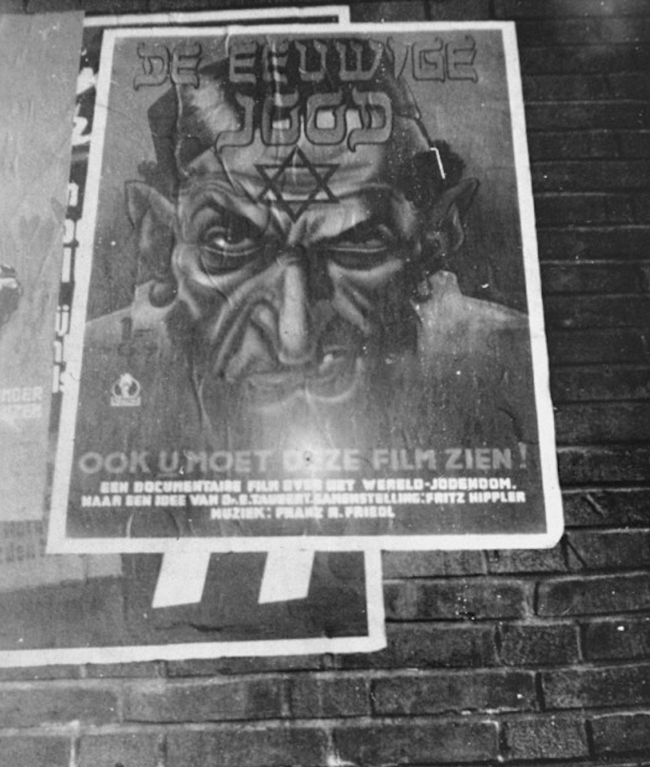 Poster advertising "Der ewige Jude" (The Eternal Jew) hangs on the side of a Dutch building.