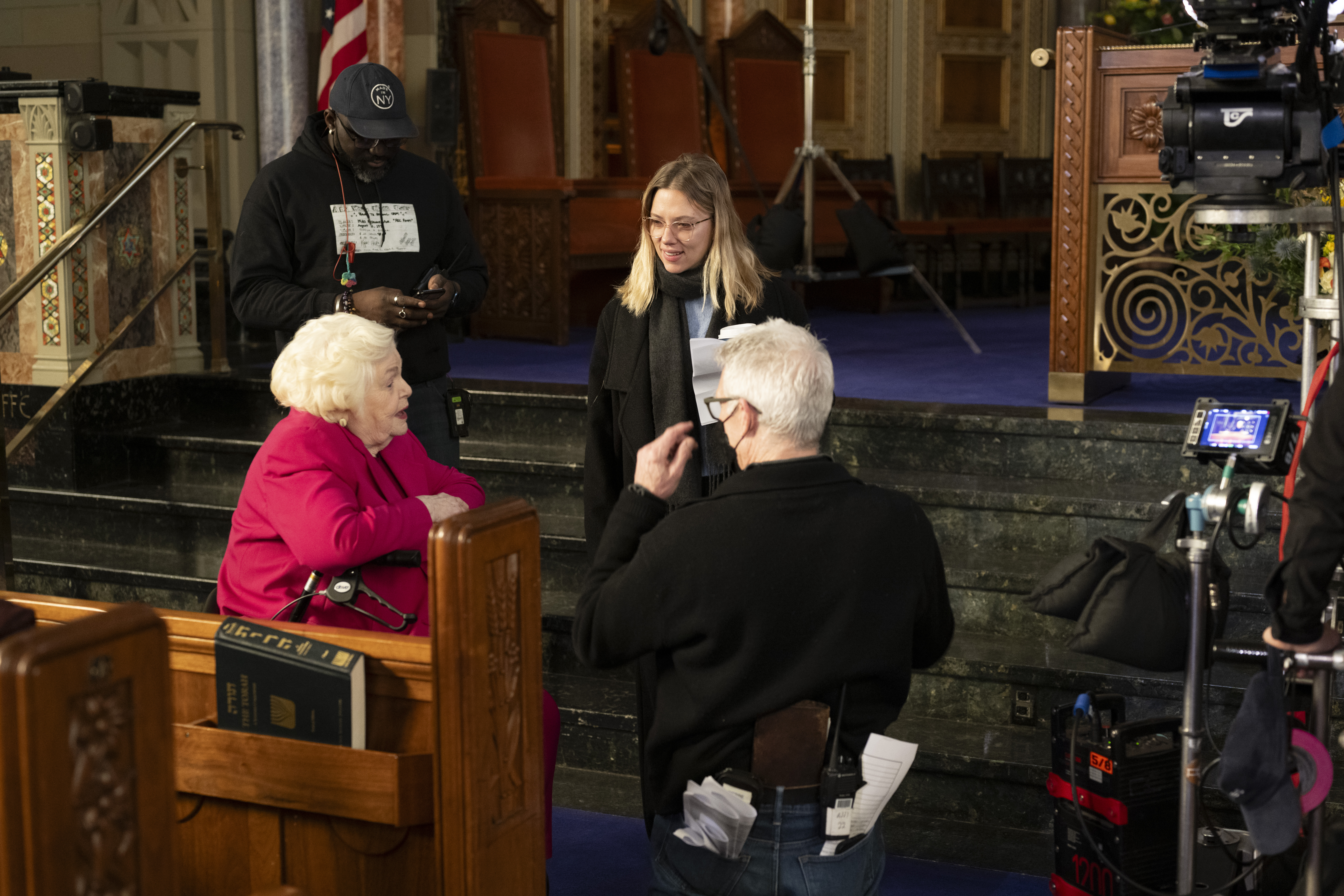 June Squibb, Scarlett Johansson and crew talk in Rodeph Shalom synagogue while filming "Eleanor the Great."