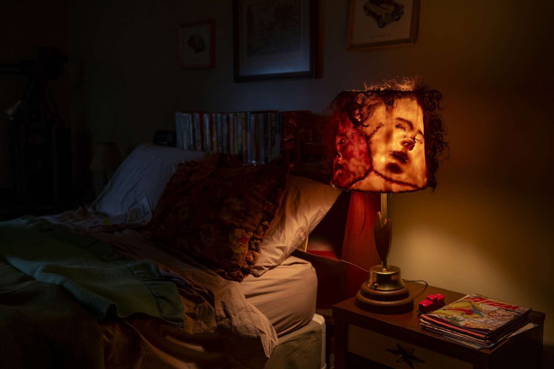A lampshade made of faces from "IT: Welcome to Derry"