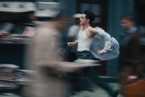 Timothee Chalamet in Marty Supreme running through the Lower East Side