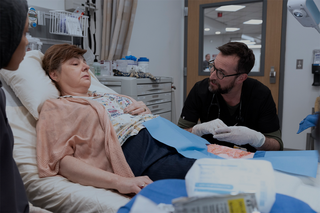 Noah Wyle as Dr. Robby and Irina Dubova as a Tree of Life Synagogue Shooting Survivor in "The Pitt."