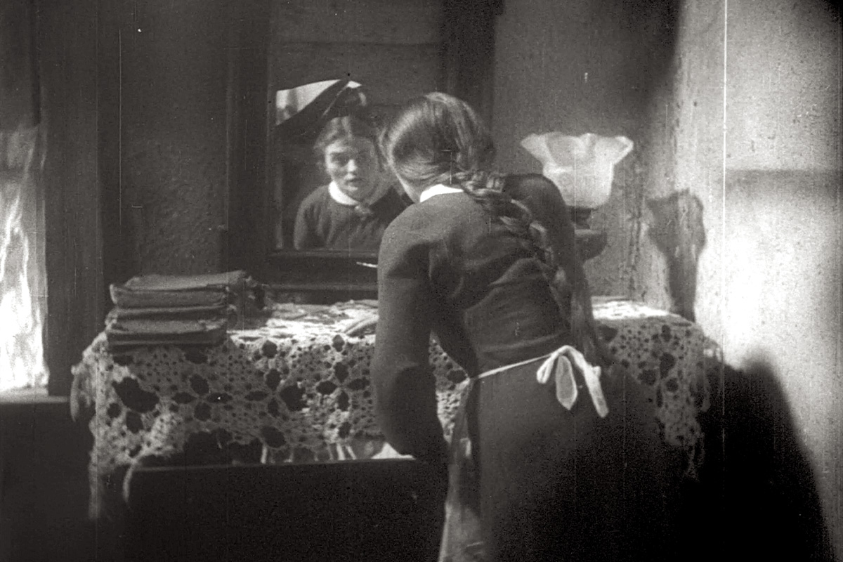 Esther stares in the mirror in "Al Khet."