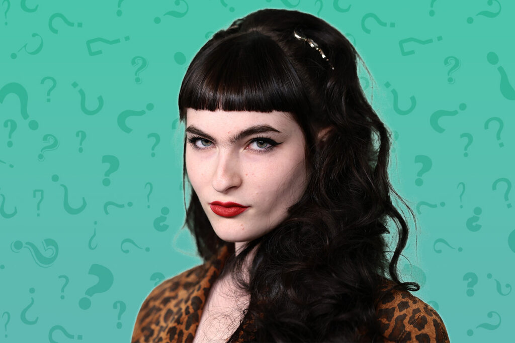 Ivy Wolk on a teal background with question marks