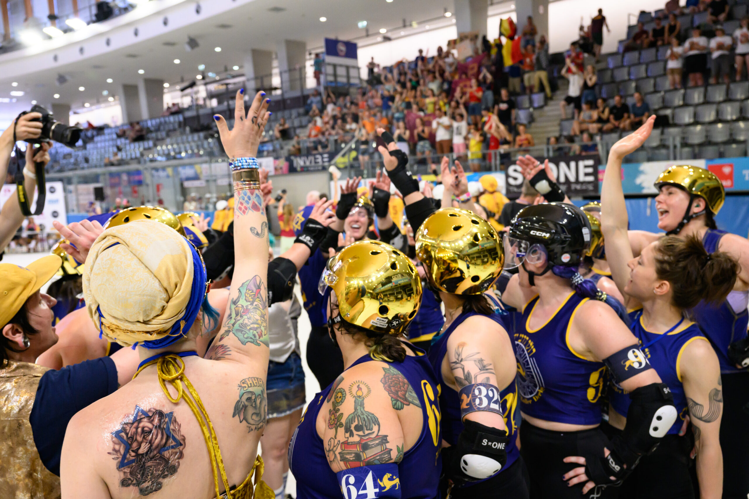 Jewish Roller Derby in a huddle at the 2025 Roller Derby World Cup.