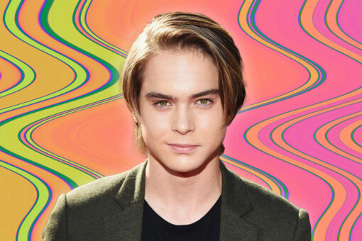 Judah Lewis from "The Floaters" in a green suit on a wavy, green and pink background.